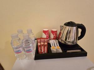 a tray with bottles of water and a tea kettle at دار الرضا Dar Al Reda in Medina