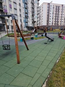 an empty playground with swings and a swing at Сучасна квартира в новобудові біля луцького кільця in Rivne