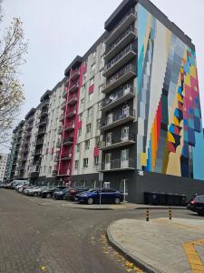 a large building with a painting on the side of it at Сучасна квартира в новобудові біля луцького кільця in Rivne