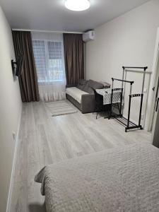 a living room with a bed and a couch at Сучасна квартира в новобудові біля луцького кільця in Rivne