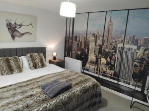 a bedroom with a bed with a view of a city at The Station Hotel Insch in Insch