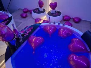 a table with purple hearts on top of it at Elite Suite in Castellana Grotte