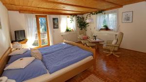 a bedroom with a bed and a table and chairs at Gästehaus Möschel in Weiler-Simmerberg