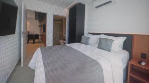 En eller flere senge i et værelse på Porto 2 Life Resort - Apartamento para 4 pessoas