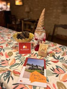 a gnome sitting on top of a table with a table cloth at Le Moulin de Giroir in Migné-Auxances