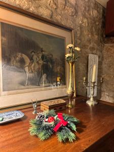 a table with christmas decorations on it with a painting at Le Moulin de Giroir in Migné-Auxances