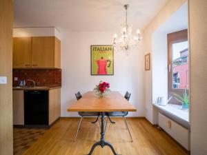 a kitchen with a wooden table and a dining room at Central Bern Flat - Balcony & Bundeshaus View in Bern