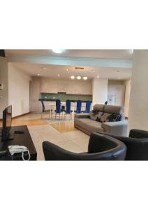 a living room with a couch and a table and chairs at Kora Hotel Suites in Addis Ababa