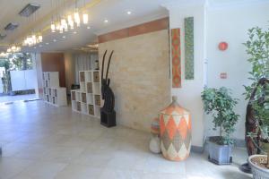 a lobby with a large vase on the wall at Kora Hotel Suites in Addis Ababa