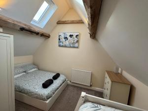 a small bedroom with a bed and a window at Woodland Forge - The Stables in Over Whitacre