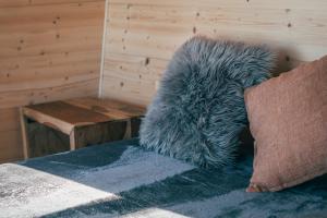 a stuffed animal sitting on the floor next to a table at Rokle Tiny house Plandry in Plandry