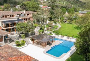 an aerial view of a house with a swimming pool at Uzhupud Garden Hotel & Lodge in Paute