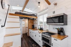 a kitchen with white cabinets and a stove top oven at Pet-Friendly Basecamp Near Zion National Park in Apple Valley