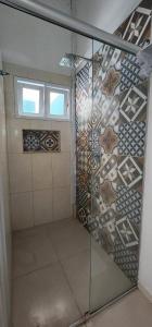 a bathroom with a shower with a glass door at Pousada Quintal da Praça in Prado +43 photos