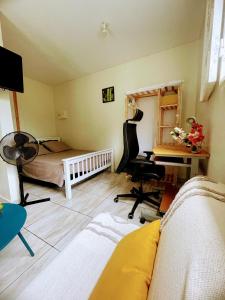 a living room with a bed and a desk and a bedroom at L essenCiel in Saint-Claude +16 photos