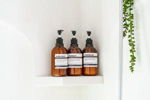 four bottles of sauce sitting on a shelf at Short North Convention King Bed Free Parking! in Columbus +70 photos