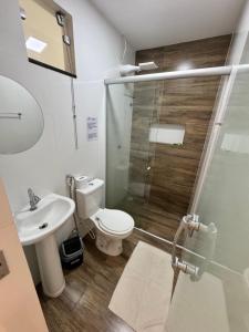 a bathroom with a shower and a toilet and a sink at Isadora Pousada in Salinópolis +5 photos