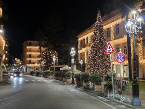 a christmas tree in the middle of a street at night at La Casa di Teo Sorrento Coast in Sant'Agnello