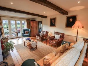 a living room with a couch and chairs at Orchard House in Leyburn