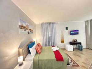 a bedroom with a bed and a couch and a tv at Casa Raffinata in Mestre