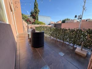 a patio with some chairs and a hedge at Boho luz terrace in San Miguel de Allende