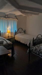 a bedroom with two beds and a window with a lamp at Casa Corazao in Urubamba +95 photos