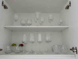a row of wine glasses sitting on a shelf at The woolshed - Oruanui in Oruanui +20 photos