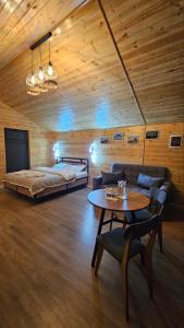 a bedroom with a bed and a table in a room at Aiwa Eco Hotel in Karakol