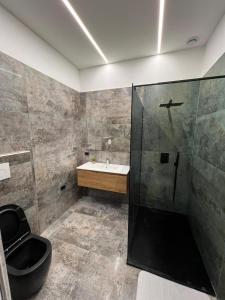 a bathroom with a shower and a sink and a toilet at Villa Uma BB in Sannicandro Garganico