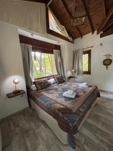 a bedroom with a large bed with a window at Ayrampo in Mar de las Pampas