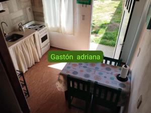 a small kitchen with a table and a kitchen with a stove at Mi casa querida in Mar de Ajó