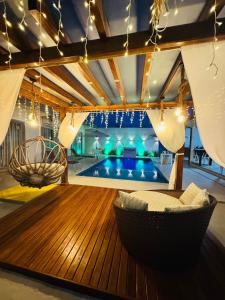 a living room with a couch and a swimming pool at Isadora Pousada in Salinópolis