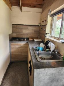 an rv kitchen with a sink and a window at Cabañas La Moneda in Rancho La Carolina