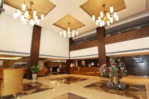 a lobby of a hotel with chandeliers at Stellar Resorts By Bel-La Monde, Rajokri, Near IGI Airport, Delhi in New Delhi