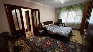 a bedroom with a bed and a table and a mirror at Hostel Apartament in Orhei +9 photos