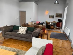 a living room with a couch and a table at High living @ Ferguson Court in Carlisle