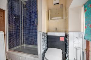 a bathroom with a toilet and a sink and a shower at The Old Bakehouse - Group Getaway in Llandysul