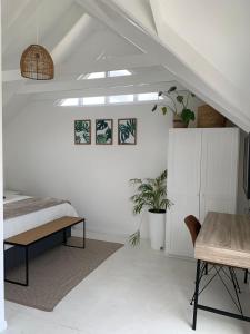 a bedroom with a bed and a desk and a table at Kommetjie's Gift - Peaceful & Private Escape in Imhoffʼs Gift