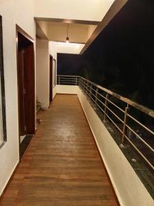 a hallway leading to a room with a wooden walkway at Hare Krishna Beach Resort in Srīvardhan
