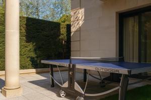 a ping pong table in front of a building at Appartement Premium 100 m2 avec Jardin Privé Plage et Centre à 400 m in Deauville