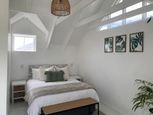 a white bedroom with a bed and a window at Imhoff's Gift Sweet Escape in Imhoffʼs Gift
