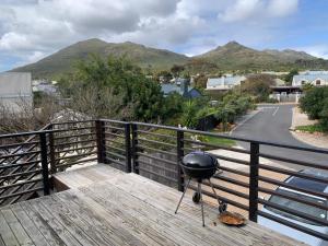 a grill on a balcony with mountains in the background at Kommetjie's Gift - Peaceful & Private Escape in Imhoffʼs Gift