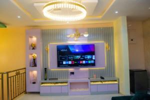 a living room with a tv on a wall at Gpark Luxury Homes And Apartments in Sagamu