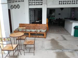 a patio with two tables and chairs and a bench at Casa familiar con piscina privada in Agua de Dios +7 photos
