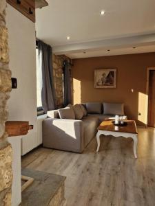 a living room with a couch and a table at Vasiliki Pramanta villas in Pramanta