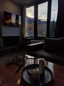 a living room with a couch and a table with candles at Vasiliki Pramanta villas in Pramanta