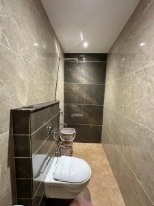 a bathroom with a toilet and a shower at Hotel Kingdom - 3 minutes From Golden Temple in Amritsar