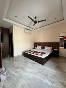a bedroom with a bed and a ceiling at Hotel Kingdom - 3 minutes From Golden Temple in Amritsar