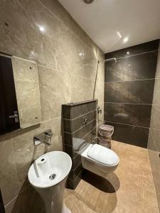 a bathroom with a toilet and a sink at Hotel Kingdom - 3 minutes From Golden Temple in Amritsar