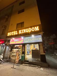 a hotel kingdom sign on the side of a building at Hotel Kingdom - 3 minutes From Golden Temple in Amritsar +16 photos